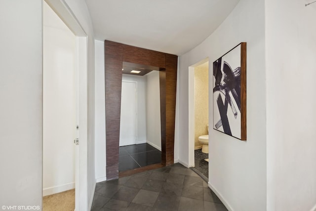 corridor with dark tile patterned flooring