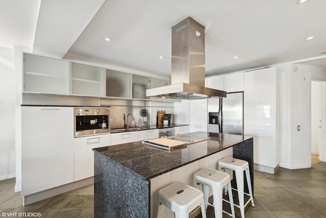 kitchen with a center island, white cabinetry, island exhaust hood, and appliances with stainless steel finishes