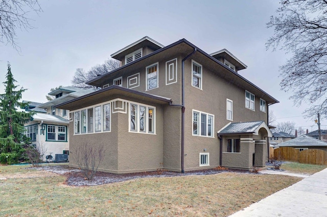 view of property exterior featuring central air condition unit, a yard, fence, and stucco siding