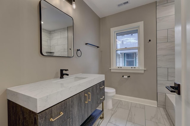 full bath featuring toilet, vanity, visible vents, baseboards, and marble finish floor