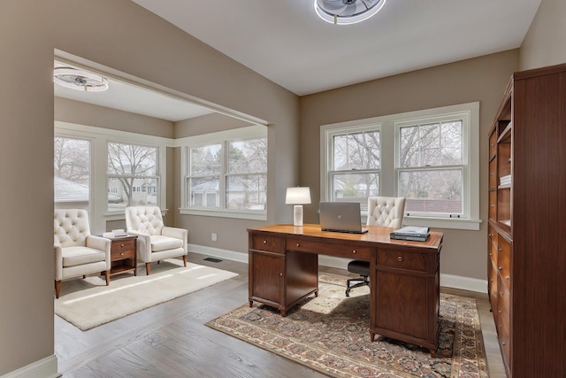 office with wood finished floors, visible vents, and baseboards