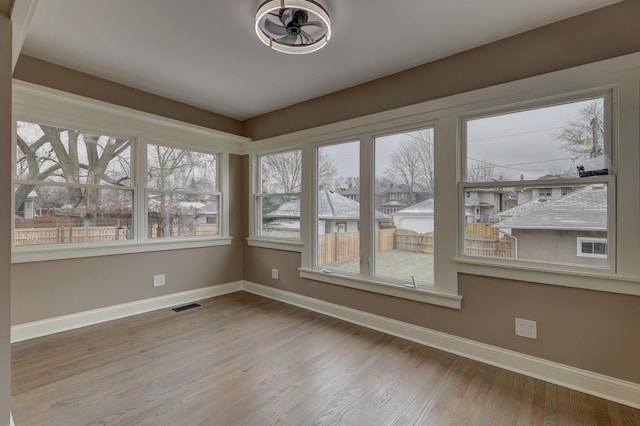 unfurnished sunroom with visible vents