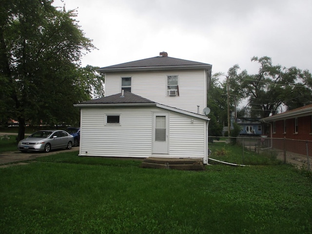 back of property featuring a yard