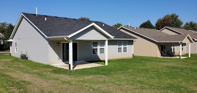 back of house with a lawn, a patio, and central AC