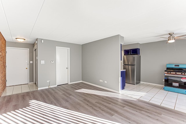 unfurnished living room with ceiling fan and light hardwood / wood-style floors