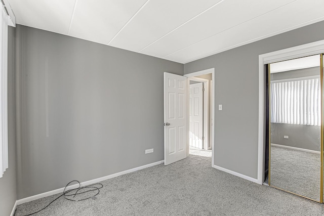 unfurnished bedroom featuring light carpet