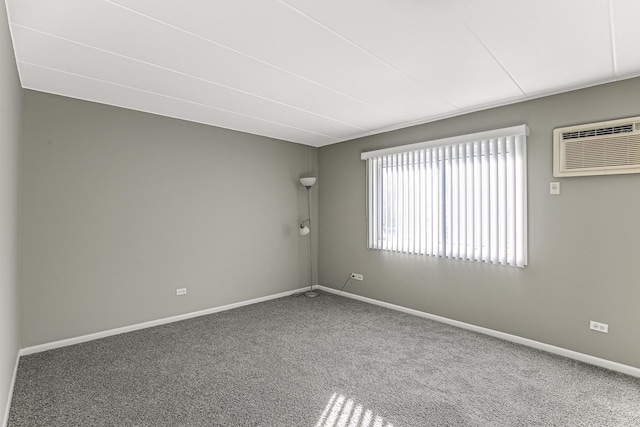 carpeted spare room with a wall mounted air conditioner