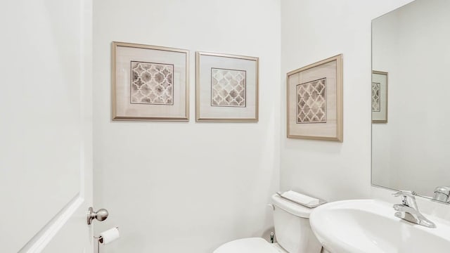 bathroom featuring sink and toilet