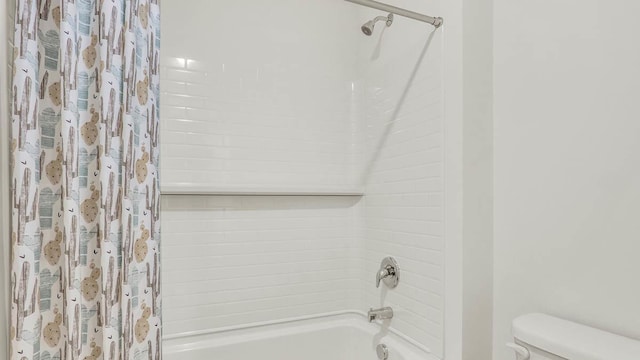 bathroom with toilet and shower / tub combo