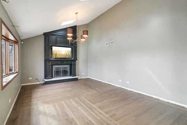 kitchen with decorative backsplash, a kitchen island, wood finished floors, a kitchen bar, and a sink