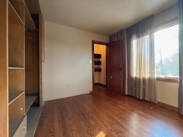 unfurnished bedroom featuring wood finished floors