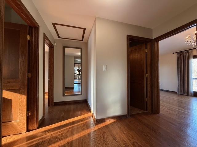 hall featuring baseboards and wood finished floors