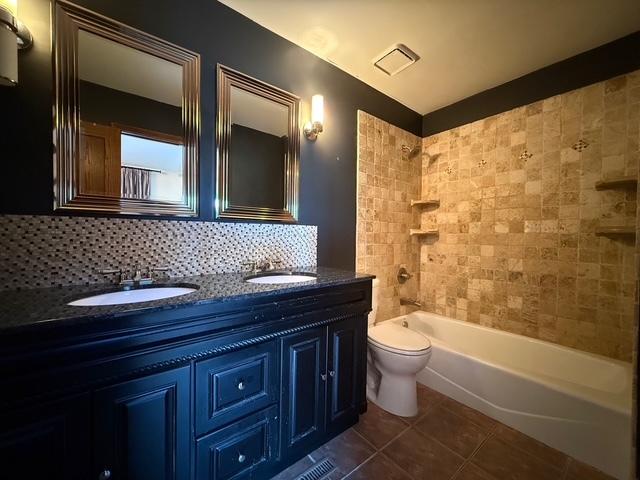 full bathroom featuring tasteful backsplash, a sink, visible vents, and tile patterned floors