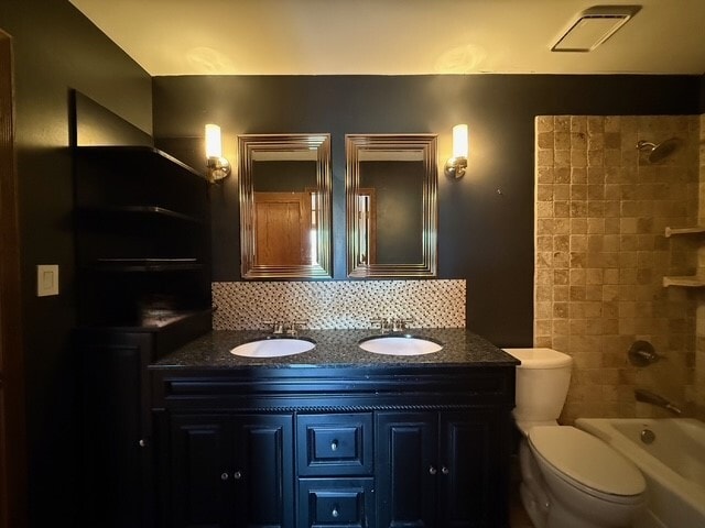 full bath featuring tasteful backsplash, a sink, and toilet