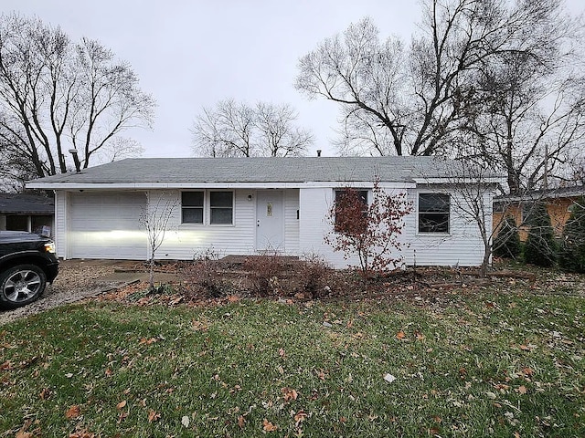 single story home featuring a front yard and a garage