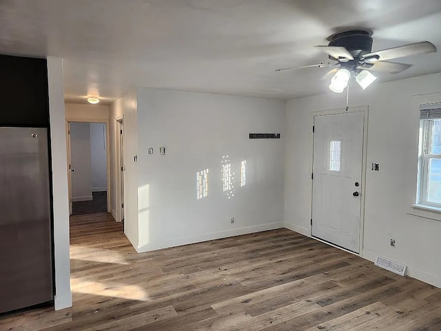 foyer entrance with hardwood / wood-style floors and ceiling fan