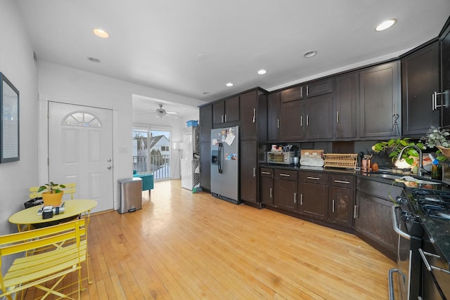 kitchen with sink, light hardwood / wood-style flooring, ceiling fan, dark brown cabinetry, and stainless steel appliances