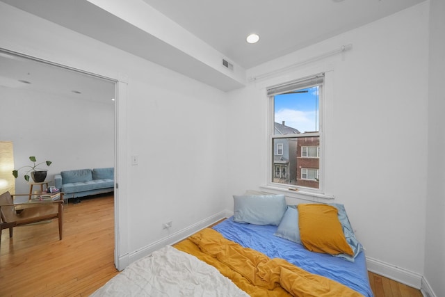 bedroom with hardwood / wood-style floors