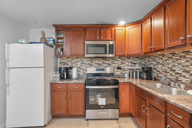 kitchen featuring decorative backsplash, sink, stainless steel appliances, and light stone counters