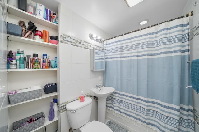 bathroom featuring shower / bath combo and toilet