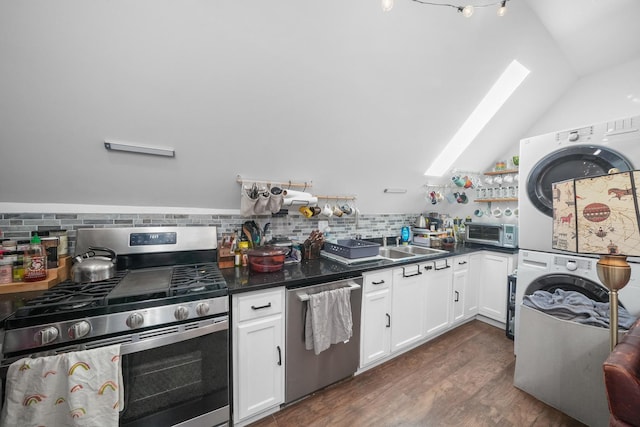 kitchen with lofted ceiling, backsplash, white cabinetry, stacked washer / dryer, and stainless steel appliances