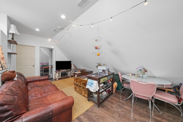 living room featuring hardwood / wood-style flooring and lofted ceiling