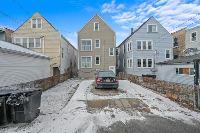 view of snow covered rear of property