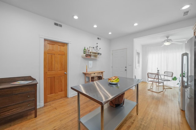 dining room with ceiling fan and light hardwood / wood-style flooring