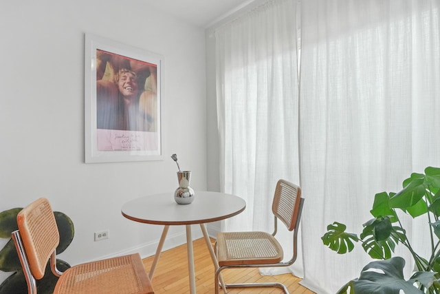 dining space with hardwood / wood-style floors