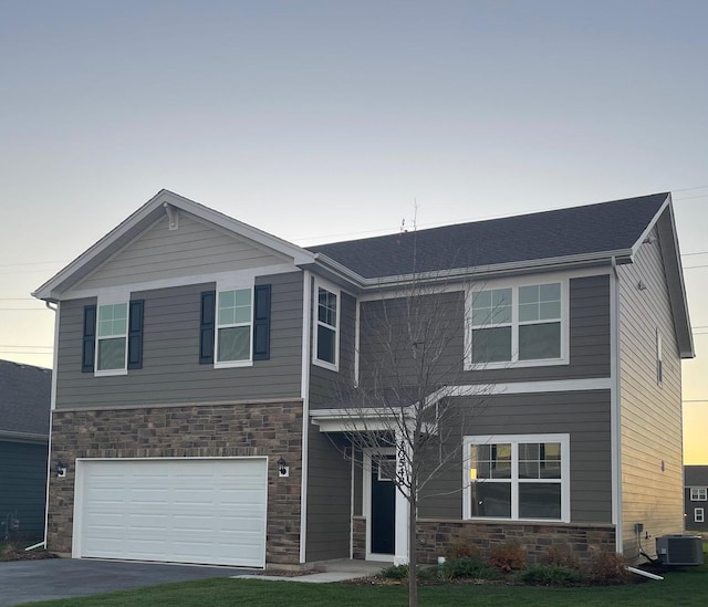 view of front of home featuring central AC unit and a garage