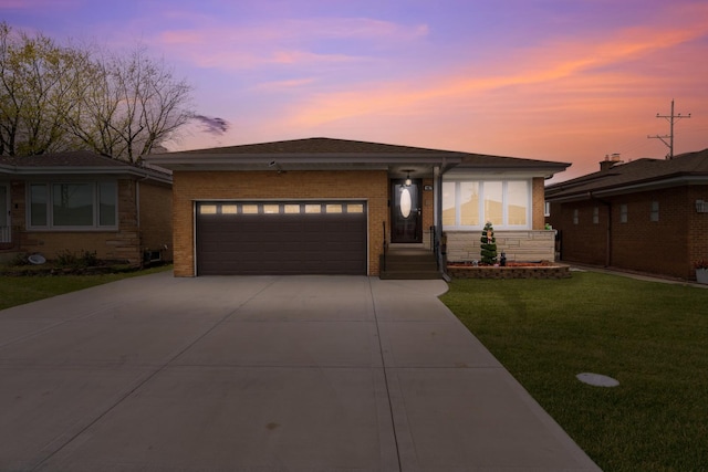 view of front of property featuring a yard and a garage