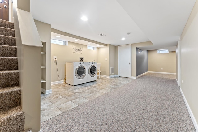 washroom with separate washer and dryer and light colored carpet