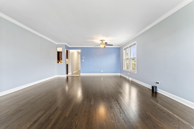 empty room featuring ceiling fan, crown molding, and dark wood-type flooring