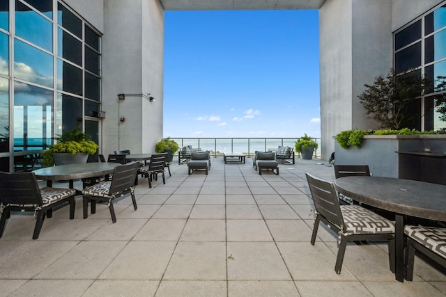 view of patio / terrace with an outdoor living space and a water view