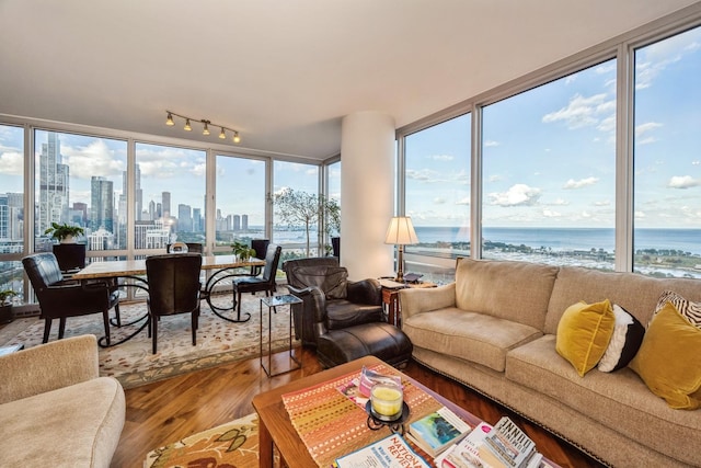 sunroom featuring a water view