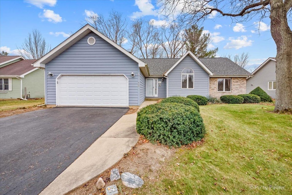 ranch-style home with a front yard and a garage