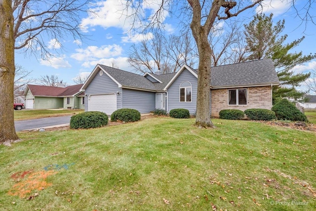 ranch-style home featuring a front lawn and a garage