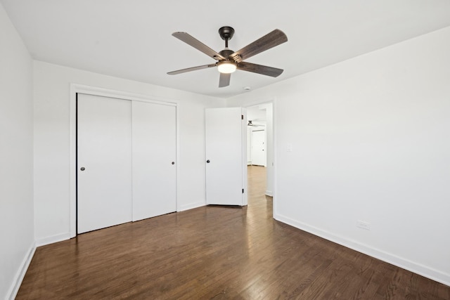 unfurnished bedroom with a closet, ceiling fan, and dark wood-type flooring