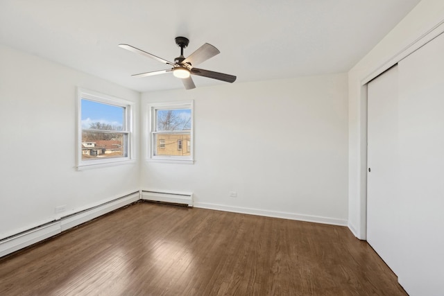 unfurnished room featuring dark hardwood / wood-style floors, ceiling fan, and baseboard heating