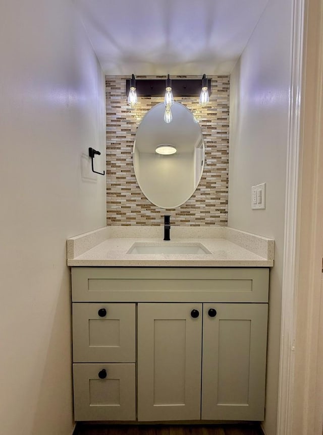 bathroom featuring vanity and tasteful backsplash