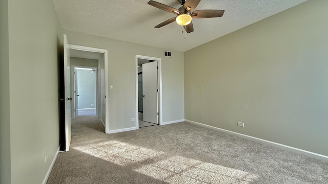 unfurnished bedroom featuring a closet, a textured ceiling, ceiling fan, and light colored carpet