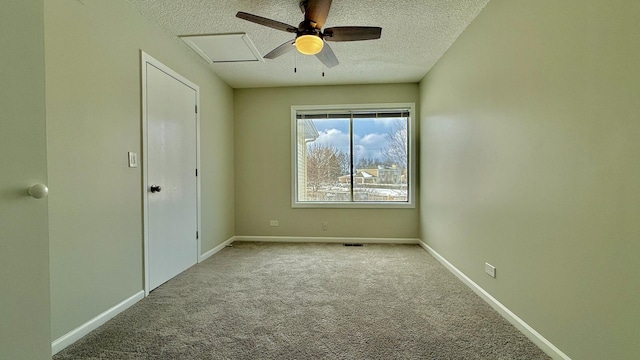 spare room featuring a textured ceiling, ceiling fan, and light carpet