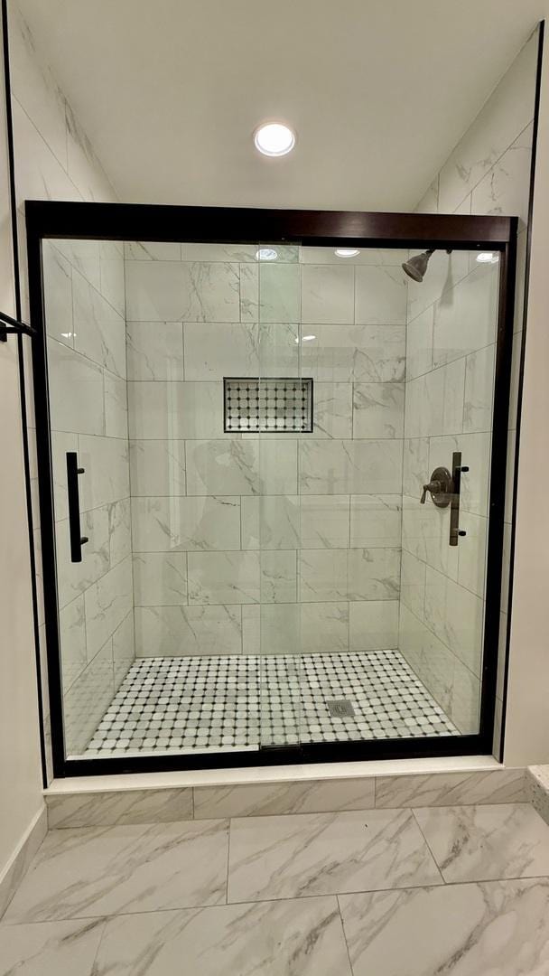 bathroom with a shower with door