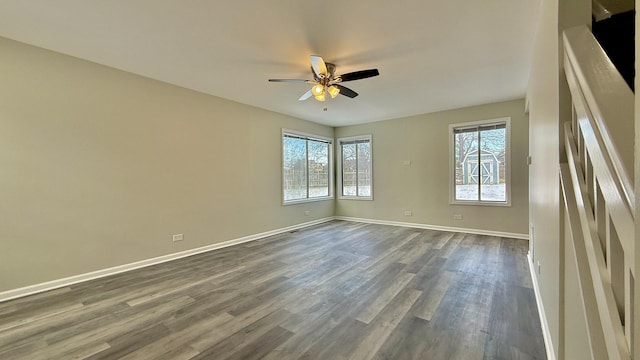 unfurnished room with dark hardwood / wood-style flooring, ceiling fan, and a healthy amount of sunlight