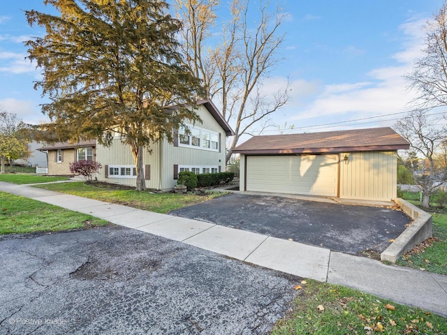 view of home's exterior featuring a garage, an outbuilding, and a yard