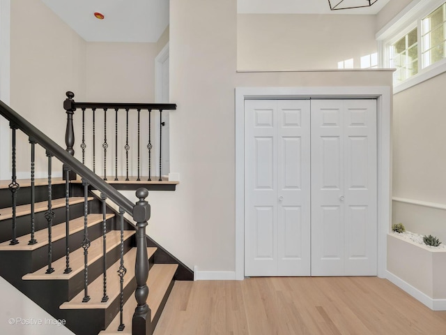 stairs with hardwood / wood-style floors