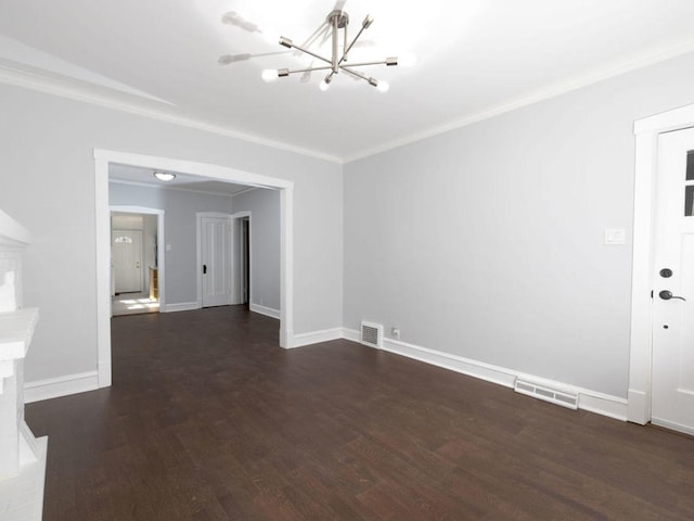 spare room with dark hardwood / wood-style floors, crown molding, and an inviting chandelier