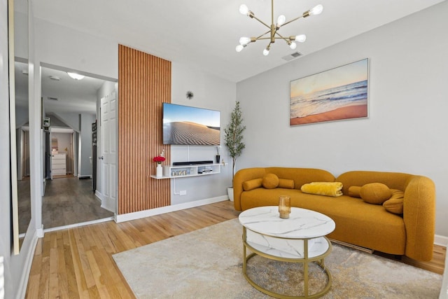 living room featuring wood-type flooring and a chandelier