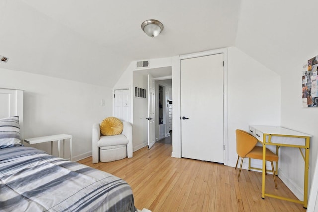 bedroom featuring vaulted ceiling and light hardwood / wood-style flooring