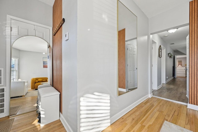 corridor with light hardwood / wood-style floors